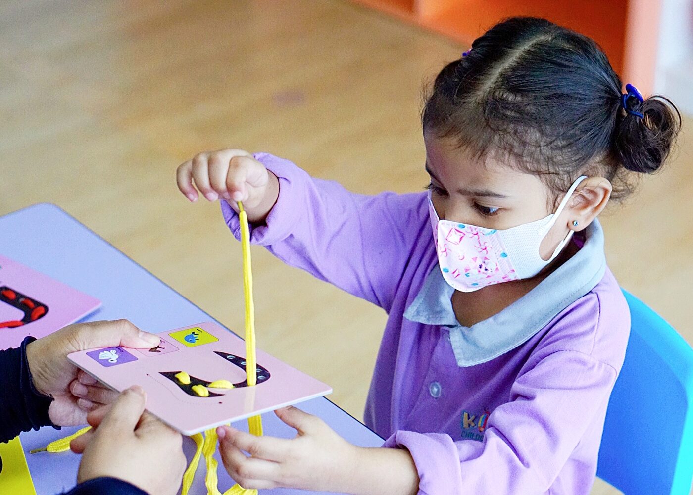 A child working with measuring cards at Kidya Childcare