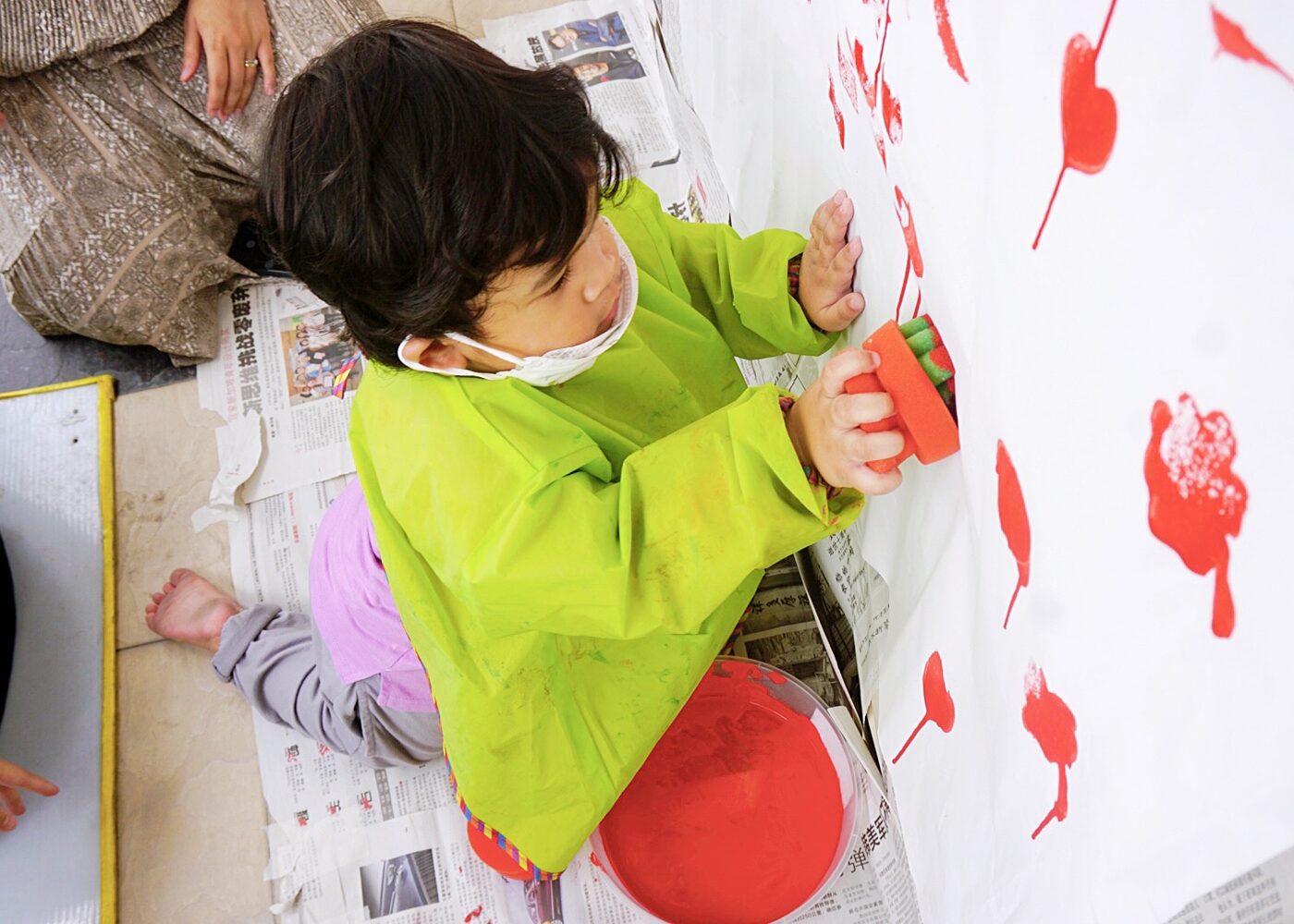 Children painting with their hands at Kidya Childcare
