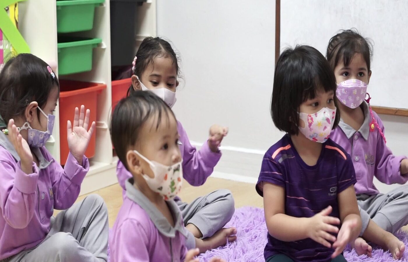 Circle time with a teacher at Kidya Childcare