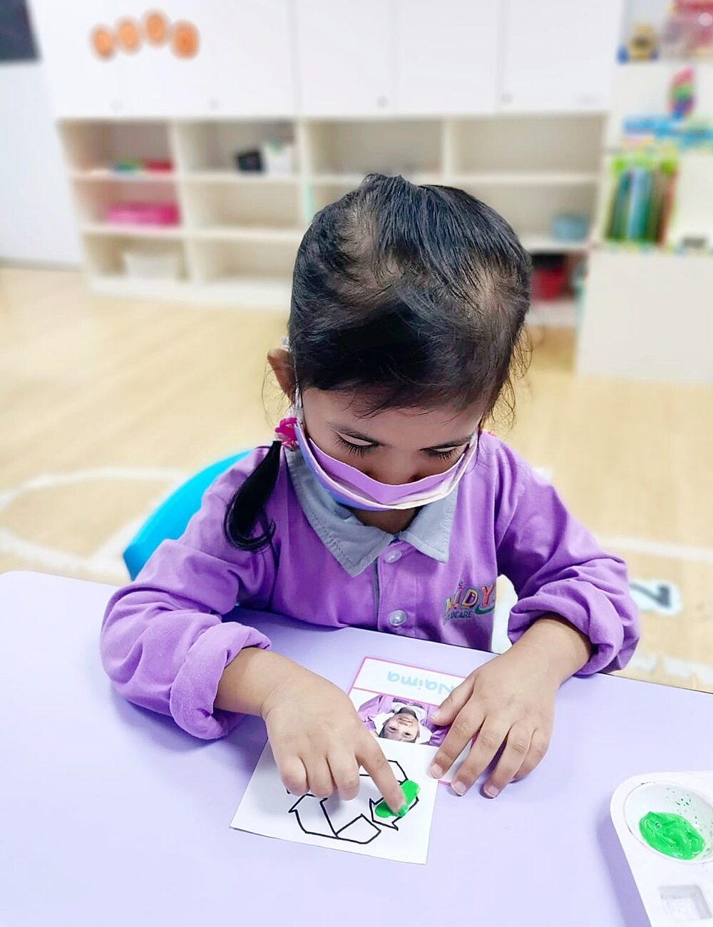 A child at Kidya working with her hands at the craft table