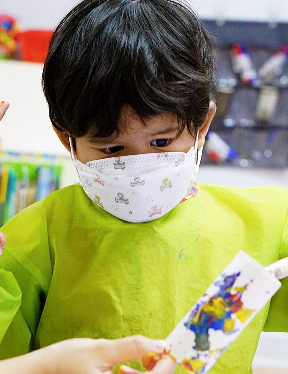 A child with his hand raised at Kidya Childcare