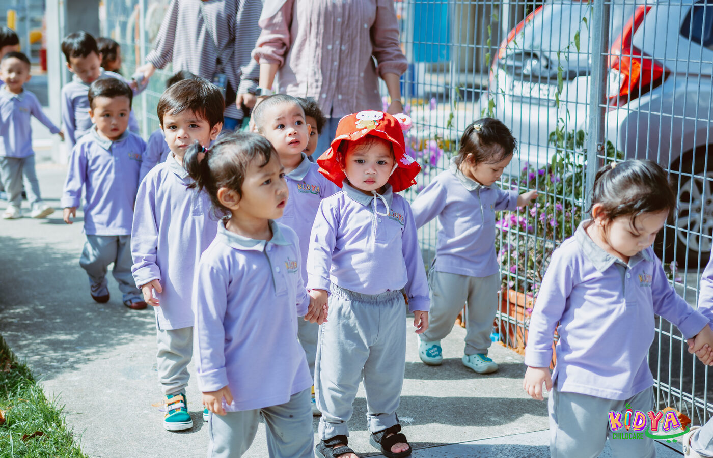 Children lining up outside with their teacher