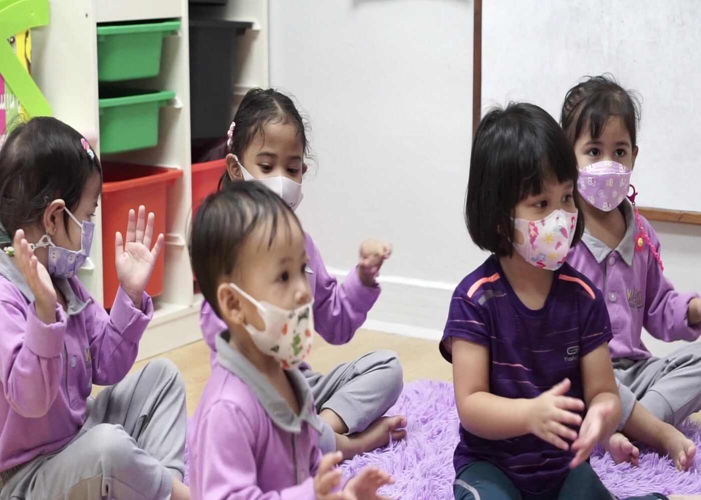 Circle time with a teacher at Kidya Childcare